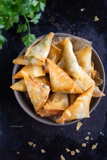 Crispy spicy pumpkin samosa filled with roasted pumpkin, paneer and Indian spices