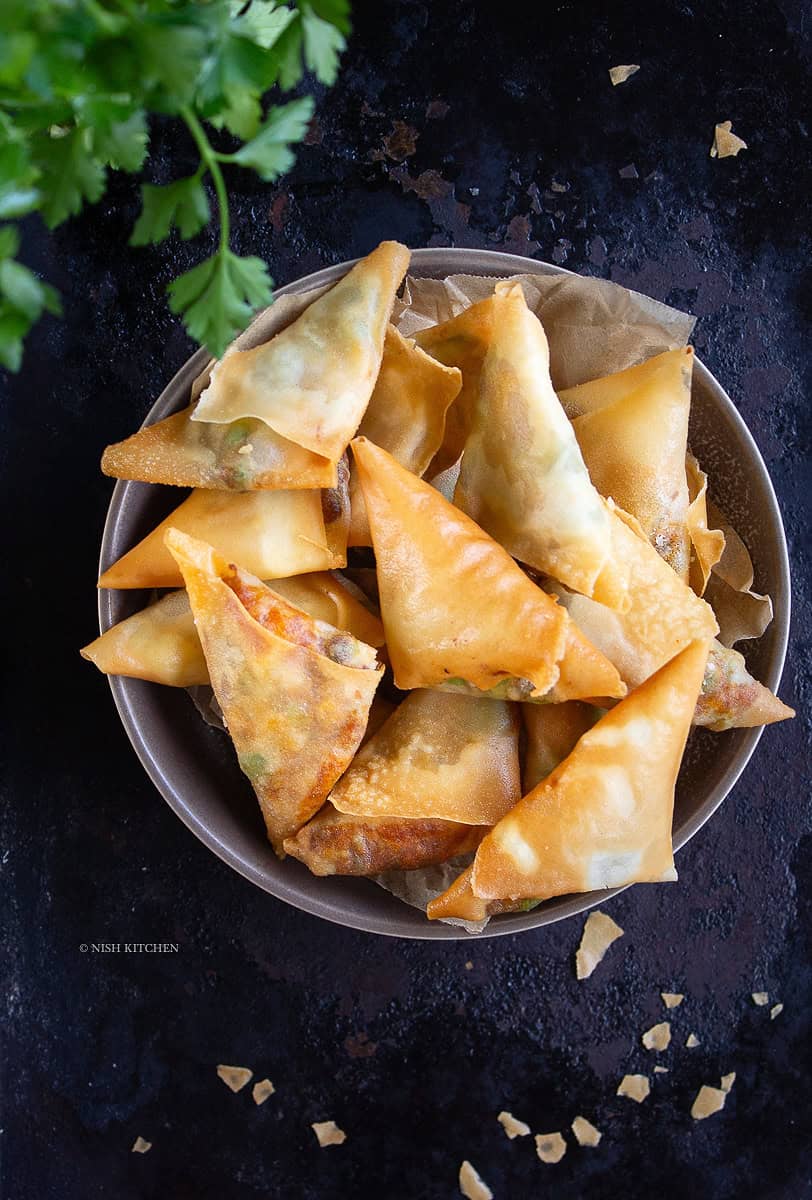Crispy spicy pumpkin samosa filled with roasted pumpkin, paneer and Indian spices